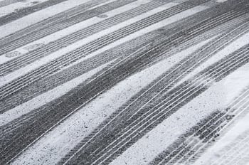 Multiple tracks of car tires, with a few footprints, in snow on pavement.jpeg Multiple tracks of car tires, with a few footprints, in snow on pavement.jpeg
